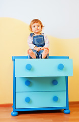 Image showing Kid sitting on the cabinet