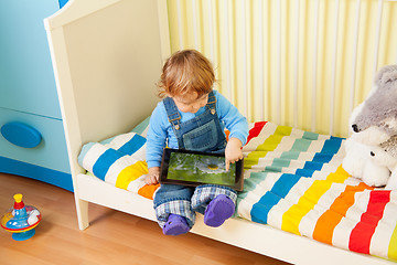 Image showing Kid playing with tablet pc