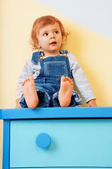 Image showing kid sitting on furniture