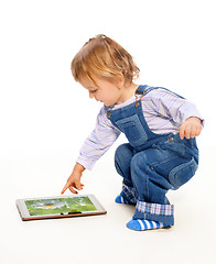 Image showing Young toddler touching tablet pc