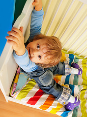 Image showing Happy kid hands on bed