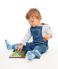 Image showing Young kid playing with tablet pc