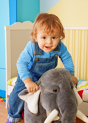 Image showing Kid riding a toy elephant