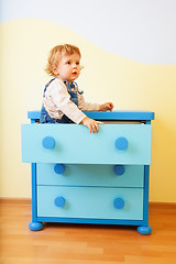 Image showing Kid sitting inside cabinet box