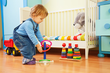 Image showing Boy playing with stacking rings