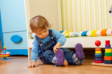 Image showing Baby putting on sandal