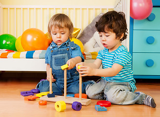 Image showing Two boys playing with pyramid blocks