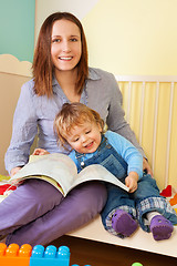 Image showing Mother and toddler reading a book