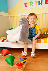 Image showing Girl sitting in the baby bed with boys