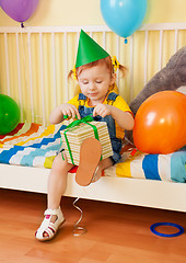 Image showing Little girl opening the present