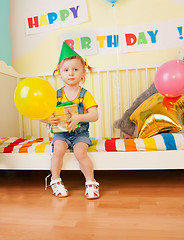 Image showing Little girl with present and baloon