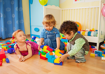 Image showing Kids playing with plastic blocks