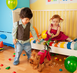 Image showing Kids playing with dog and having party