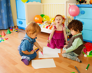 Image showing Tree kids drawing sitting on the floor