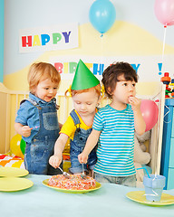 Image showing Three kids eating cake on the birthday party