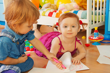 Image showing Boy and girl drawing with crayons