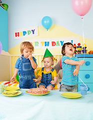 Image showing Three kids eating birthday cake