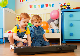 Image showing Girl with boy playing piano