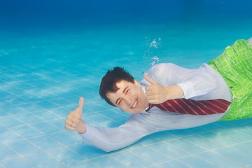 Image showing Happy businessman underwater