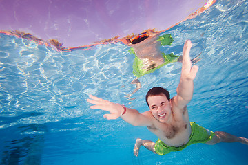 Image showing Happy man diving underwater