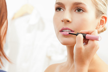 Image showing Applying pink lipglass