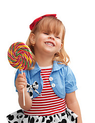 Image showing Happy girl smiling and holding lollipop