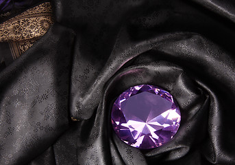 Image showing Pink diamond in the black fabric