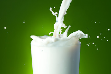 Image showing Filling the glass with milk