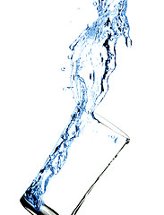 Image showing water splashing out of glass with water