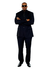 Image showing African corporate man standing with crossed arms