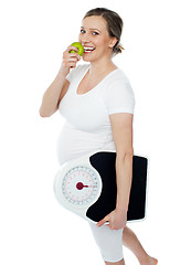 Image showing Young pregnant woman enjoy fresh green apple