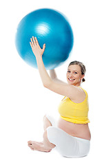 Image showing Smiling pregnant woman with a ball