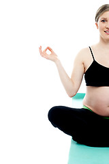 Image showing Cropped image of a pregnant lady doing yoga