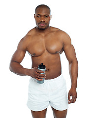 Image showing Athlete posing with health drink bottle