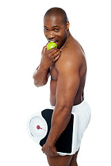 Image showing Young man enjoying fresh green apple