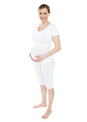 Image showing pregnant woman caressing her belly