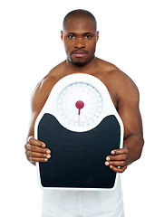 Image showing Attractive athlete showing weighing scale