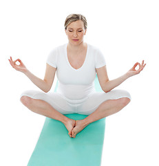Image showing Young woman meditating in lotus pose