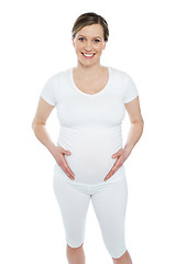 Image showing Pregnant woman holding her tummy