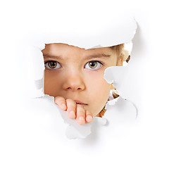 Image showing Child's face looking through a hole in paper