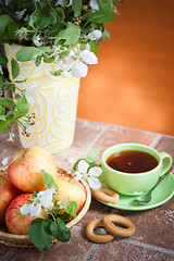 Image showing Beautiful ripe apples and branches of a blossoming apple-tree in