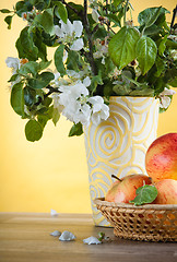 Image showing Beautiful ripe apples and branches of a blossoming apple-tree in