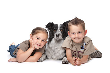 Image showing Two kids and a dog