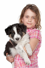 Image showing Girl and border collie puppy