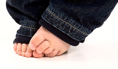 Image showing Baby feet and denim