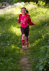 Image showing Pretty young girl running in the park