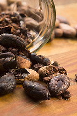 Image showing Cocoa (cacao) beans on natural wooden table