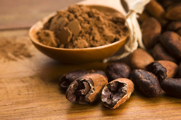 Image showing Cocoa (cacao) beans on natural wooden table