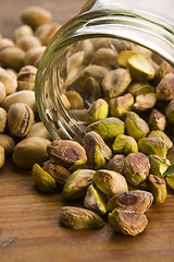 Image showing Roasted pistachios on natural wooden table