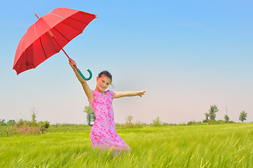 Image showing teenage girl with red umbrella in wheat field